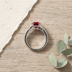 Round Ruby Split Shank Engagement Ring placed on table