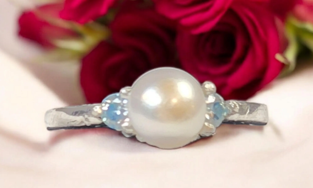 Elegant sterling silver ring featuring a large, lustrous 8mm freshwater pearl as its centerpiece