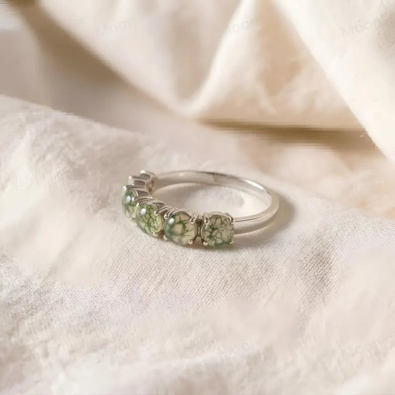 Moss agate wedding band featuring five round-cut moss agate stones on a silver band.