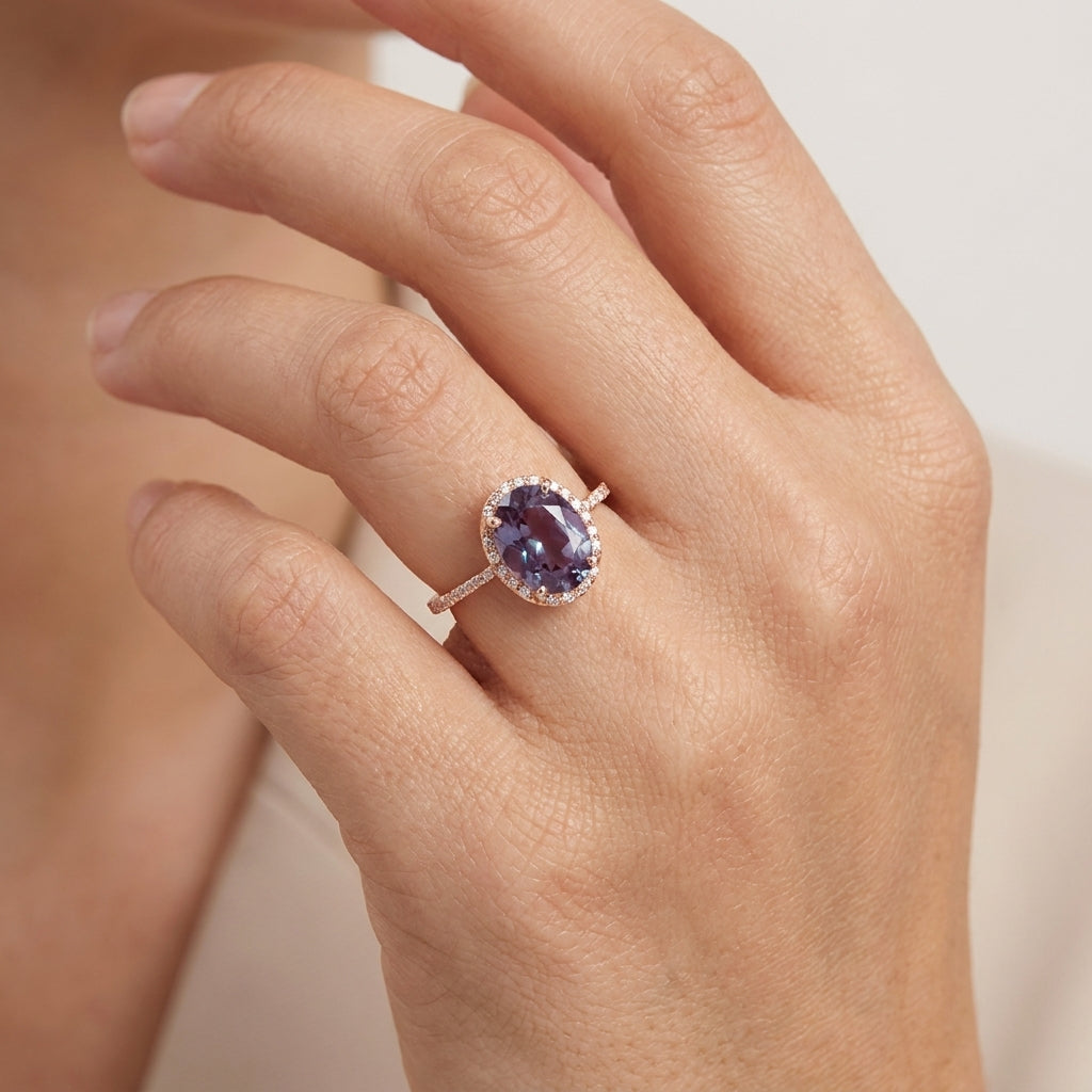 Oval Alexandrite Color-Change Stone 14K Rose Gold Halo Diamond Engagement Ring With Model Hand