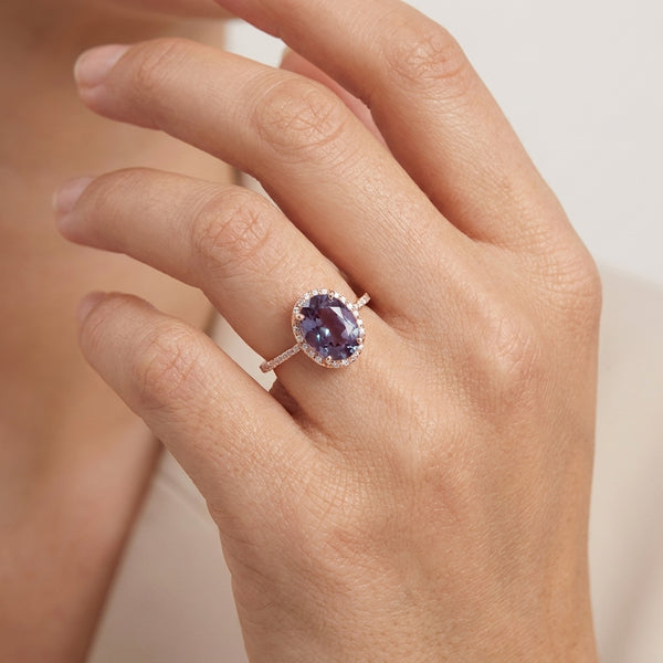 Oval Alexandrite Color-Change Stone 14K Rose Gold Halo Diamond Engagement Ring With Model Hand