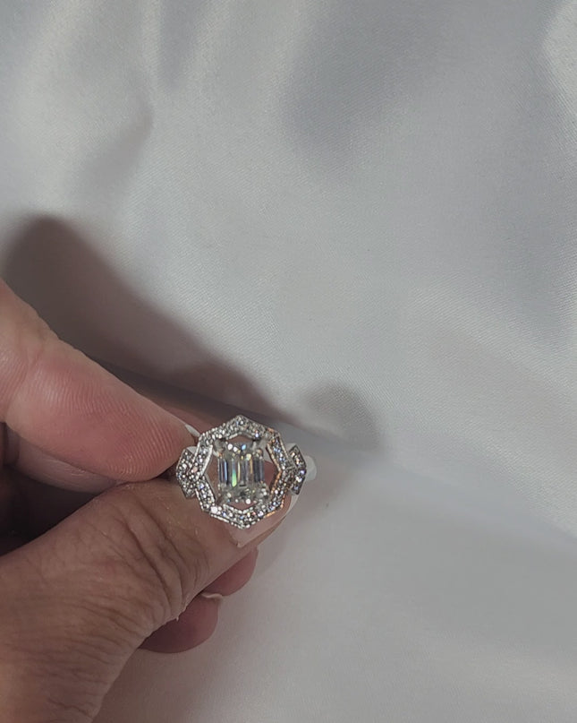 2ct Emerald Cut Moissanite ring enhanced by moissanite halo setting.