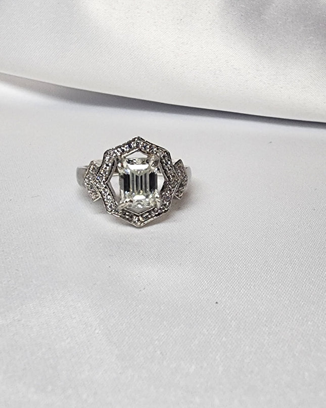 2ct Emerald Cut Moissanite ring enhanced by moissanite halo setting.