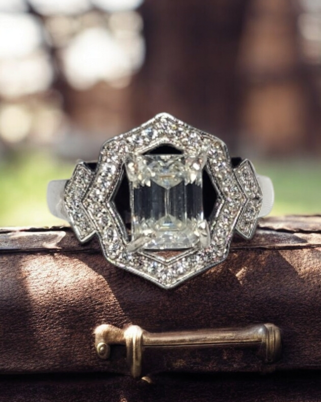 2ct Emerald Cut Moissanite ring enhanced by moissanite halo setting.