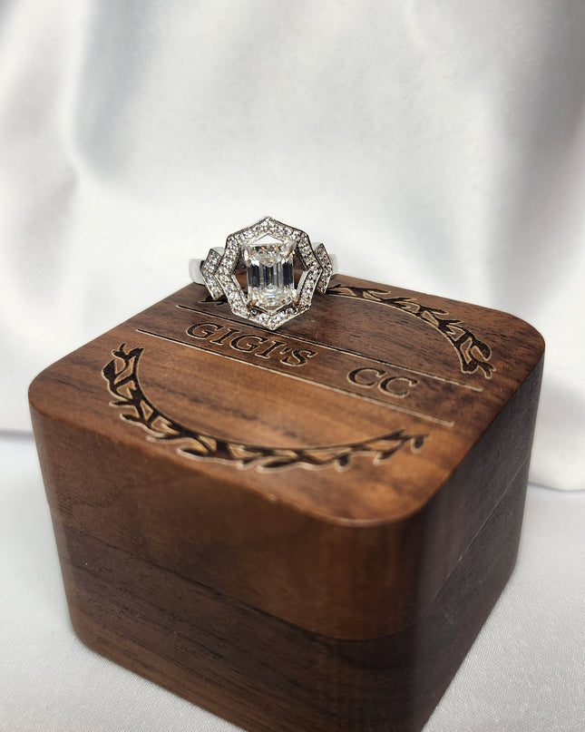 2ct Emerald Cut Moissanite ring enhanced by moissanite halo setting.