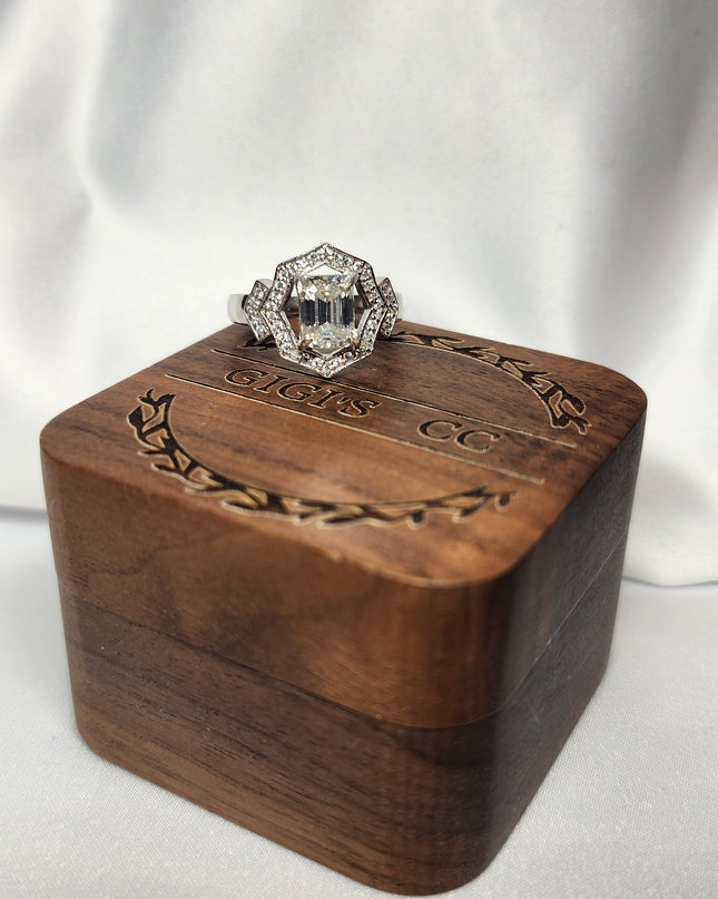 2ct Emerald Cut Moissanite ring enhanced by moissanite halo setting.
