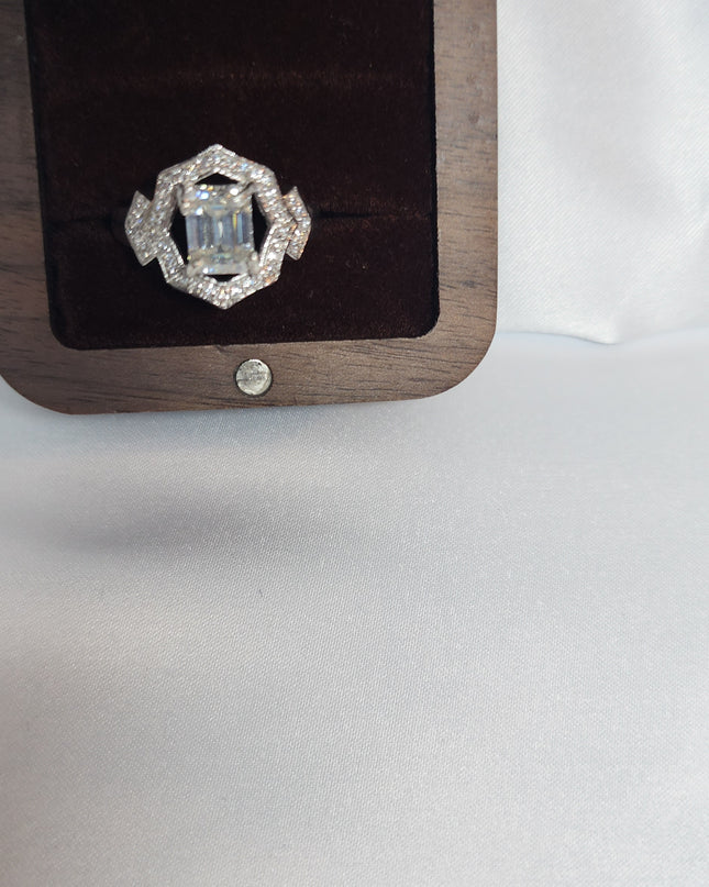 2ct Emerald Cut Moissanite ring enhanced by moissanite halo setting.
